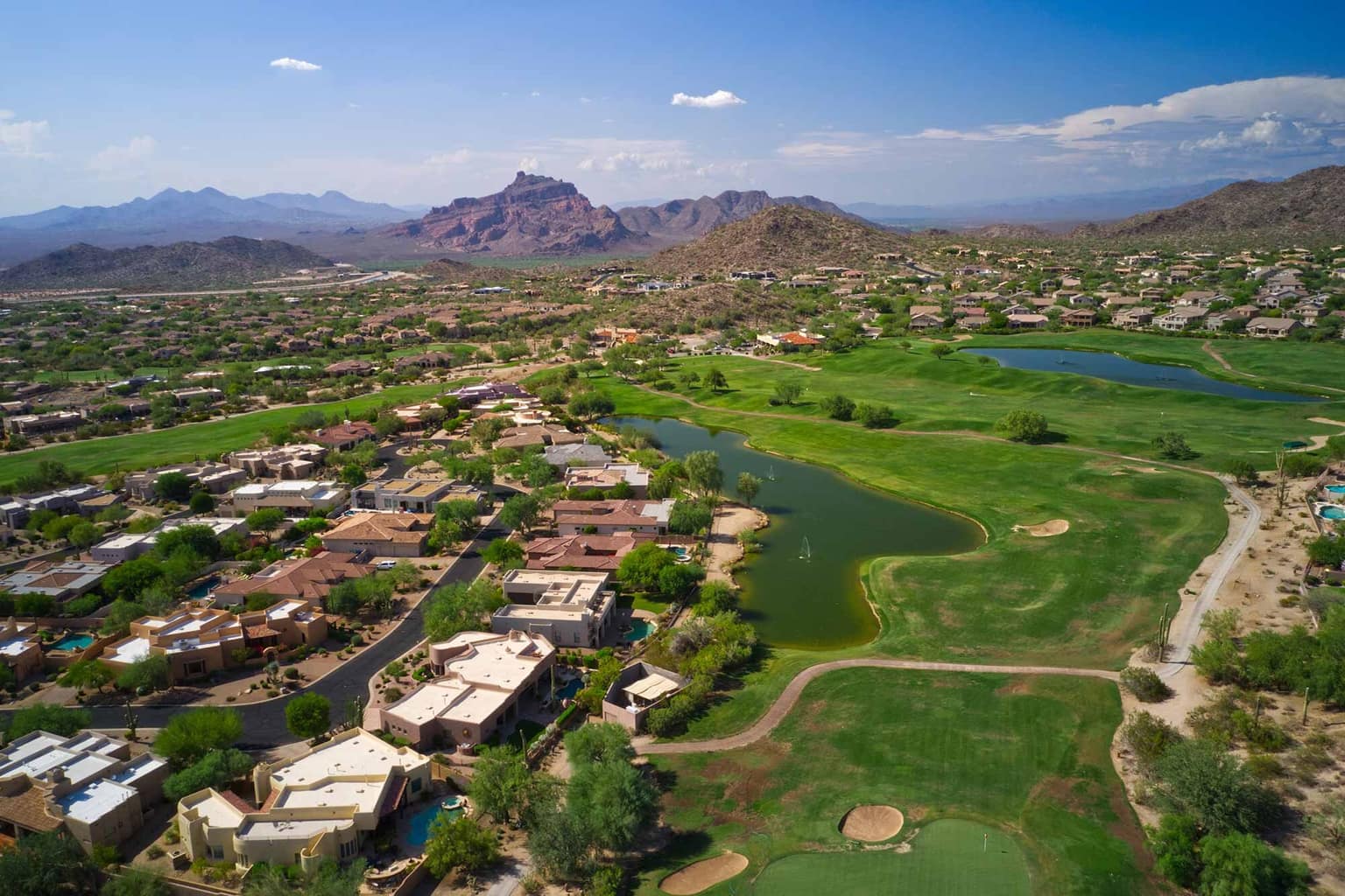 Aerial view of a Coachella Valley golf community against the mountains